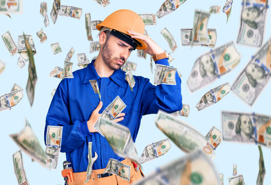 Young hispanic man wearing worker uniform touching forehead for illness and fever, flu and cold, virus sick