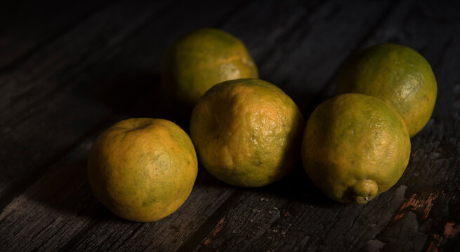 Sweet lime fruits on dark wooden table