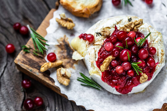 Baked cheese Camembert with cranberries and nuts. Gourmet appetizer. Breakfast, Food recipe background