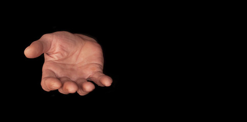 Male hand on a dark background, showing empty asking hand. Praying hand with faith in religion and...
