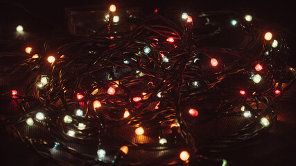 Christmas garland in retro style. Garland, lights, dark background, retro.