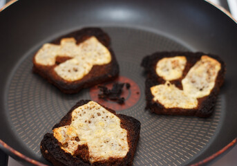 Three cheese sandwiches with cheese burned