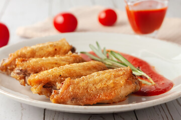 Buffolo wings close-up with tomato sauce and tomatoes