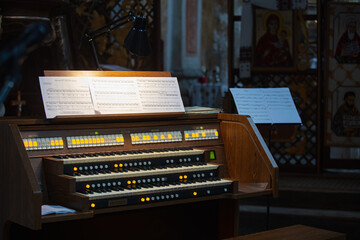 Interior of Roman Catholic Church of Nativity of the Blessed Virgin Mary in Komarno, Lviv region, Ukraine. Modern organ console