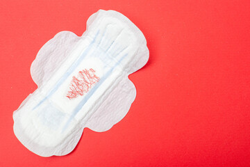 Feminine pad on a red background. Hygiene product for menstruation.
