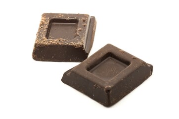 Chocolate chips on white background. Sweet food studio shot with selective focus