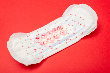 Feminine pad on a red background. Hygiene product for menstruation.