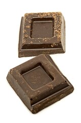 Chocolate chips on white background. Sweet food studio shot with selective focus