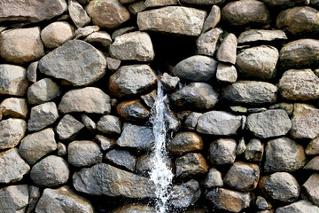 view of water falling from small stone wall at bilpudi (Gujarat) (India)