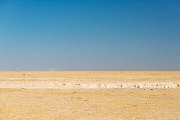 Kalahari desert, salt flat, no where, empty plain, clear sky, road trip in Botswana, travel destination in Africa.