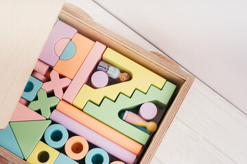 Children's toys made of natural material. Wooden construction kit in a large box-cars made of plywood.