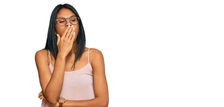 Young african american woman wearing casual clothes and glasses bored yawning tired covering mouth with hand. restless and sleepiness.