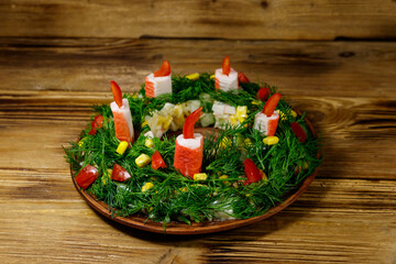 Salad Christmas wreath on a wooden table © olyasolodenko