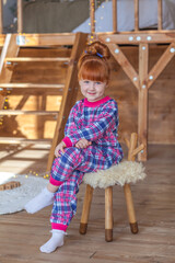 happy little girl playing near christmas tree at home, winter holidays, real people