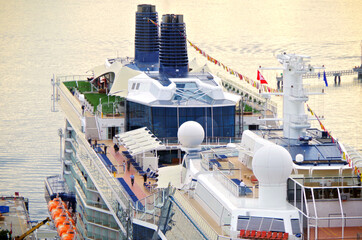 Aerial drone birdseye view over open outdoor decks of modern Celebrity cruiseship or cruise ship...