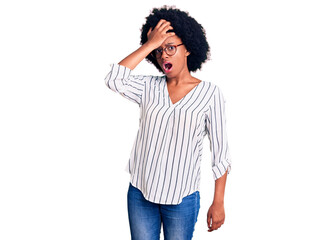 Young african american woman wearing casual clothes and glasses surprised with hand on head for mistake, remember error. forgot, bad memory concept.