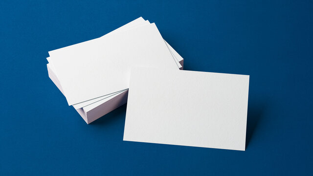 Business card mockup resting on a stack of cards. Branding design concept. Insert your design