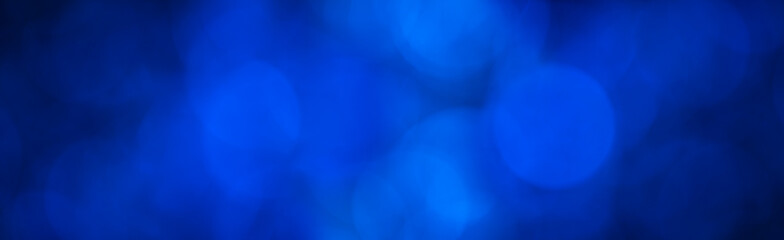 blue abstract background banner with blue bokeh light effect in the dark with copy space