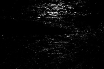 Night ripples of the ocean shiny surface. Reflection of moonlight in the dark abyss of waters. Dangerous sea depth for background. Gloomy stormy massive tide on the coast.Deep black vintage surf beach