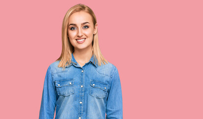 Fototapeta premium Beautiful caucasian woman wearing casual denim jacket with a happy and cool smile on face. lucky person.