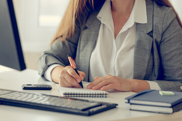 Close up of business lady hands making notes