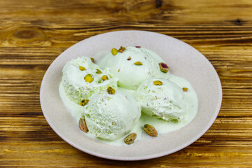 Pistachio ice cream on wooden table