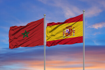 Flag of Morocco and Spain over a sky background
