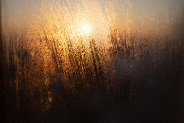 Sunset on fogged glass background