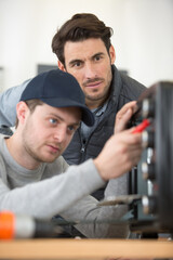 Fototapeta na wymiar two men checking a broken oven