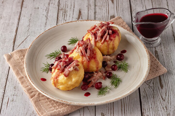 Swedish potato dumplings with cranberry sauce on a light background