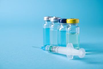 Bottle of coronavirus vaccine with syringe for injection