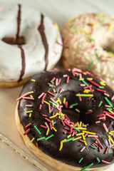 Various fresh-baked donuts on a wooden background