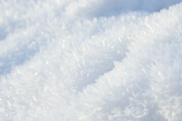 Hoarfrost background texture. Fresh ice and snow winter backdrop with snowflakes and mounds. Seasonal wallpaper. Frozen water geometrical shapes and figures. Cold weather atmospheric precipitation.