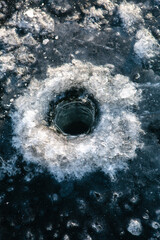 Hole in the ice for fishing in winter