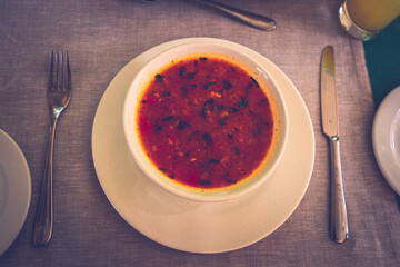 Kharcho - traditional Georgian soup containing beef, rice, cherry plum puree and chopped walnuts