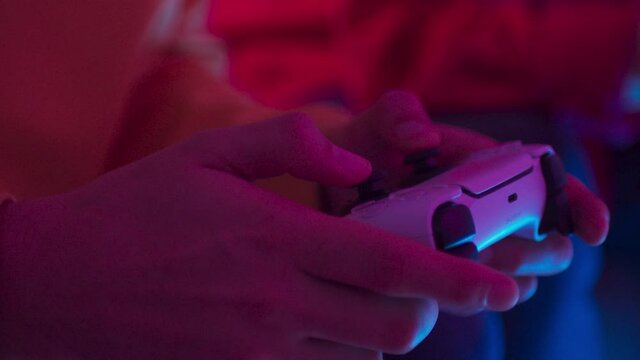 Excited friends father and son playing online video games on modern console next gen 2020, new era of consoles, white gamepad, man group at home play games