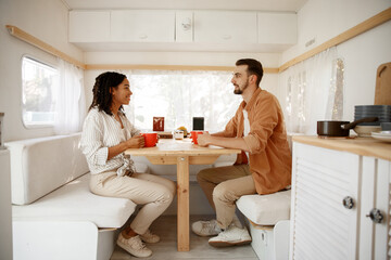 Love couple having breakfast in rv, camping