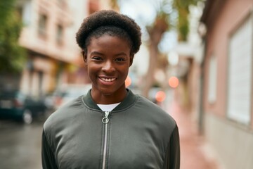 Young african american girl smiling happy standing at the city.