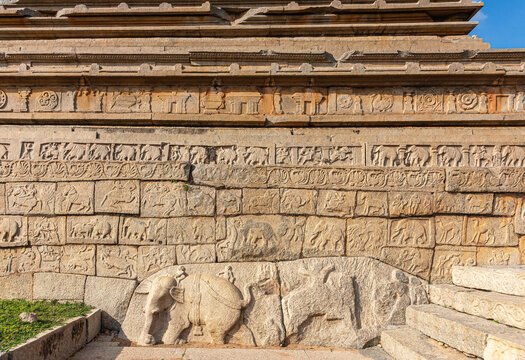 Hampi, Karnataka, India - November 4, 2013: Part Of Base Of Mahanavami Dibba Or The Dussehra Platform. All Around Brown Stone Mural Sculptures.