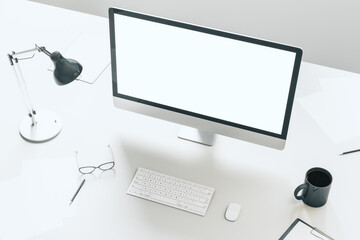 Contemporary desktop with empty white computer screen