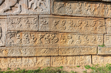 Hampi, Karnataka, India - November 4, 2013: Mural sculpture on stone at Royal Enclosure. base of Mahanavami Dibba or the Dussehra Platform. Images of mostly women.