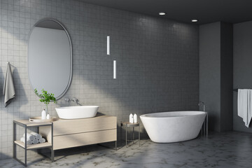 Obraz na płótnie Canvas Freestanding bath with mirror in comfortable gray bathroom interior