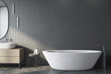 Fototapeta na wymiar Freestanding bath with mirror in gray modern bathroom.