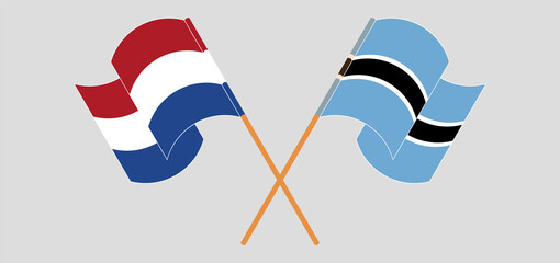 Crossed and waving flags of the Netherlands and Botswana