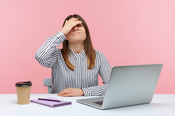 Upset frustrated woman office worker in striped shirt touching face with hand making facepalm...