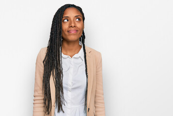 African american woman wearing business jacket smiling looking to the side and staring away thinking.