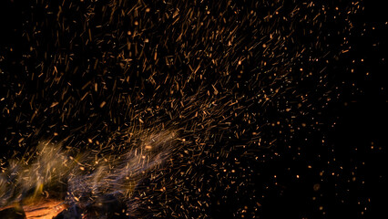 Fire particles, towards the sky. Abstract dark glitter fire particles lights texture or background...