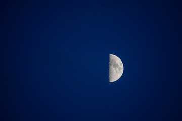 Half moon in the blue sky.