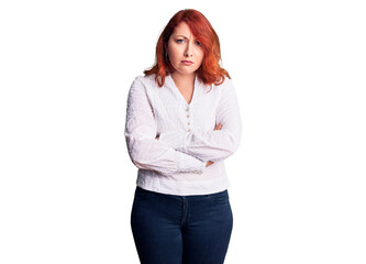 Young beautiful redhead woman wearing casual shirt skeptic and nervous, disapproving expression on face with crossed arms. negative person.