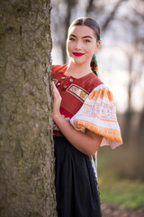 Young beautiful slovak woman in traditional dress. Slovak folklore